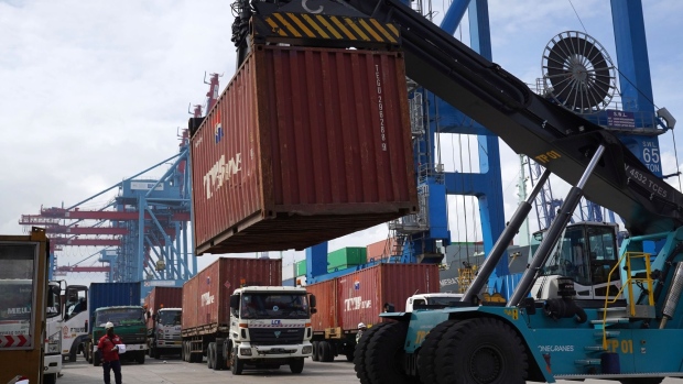A reach stacker moves a shipping container in the IPC Container Terminal at Tanjung Priok Port in Jakarta, Indonesia, on Friday, Dec. 10, 2021. Indonesia is scheduled to announce trade figures on Dec. 15. Photographer: Dimas Ardian/Bloomberg