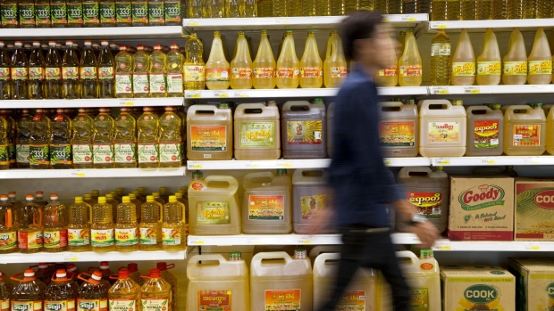 A customer walks past cooking oil displayed on shelves inside an Ocean Supercenter store, operated by City Mart Holdings Co., in Yangon, Myanmar, on Saturday, March 11, 2017. City Mart has 20 years of market knowledge to help it compete against international players, said Win Win Tint, managing director of City Mart in a Bloomberg interview on March 9.