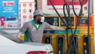An attendant wears a protective face mask while using a fuel pump at an Eppco, also known as Emirates Petroleum Product Co., gas station in Dubai, United Arab Emirates, on Tuesday, March 10, 2020. The Middle Easts travel and business hub called on citizens and residents to avoid travel due to the coronavirus risk.