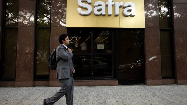 A man walks past a Banco Safra SA branch on Avenida Paulista in the financial district of Sao Paulo, Brazil, on Wednesday, Feb. 15, 2012. Brazil’s deposit insurance fund, the nation’s privately owned guarantor of bank deposits and financial stability, almost doubled its assets since 2008 to 28 billion reais ($16.3 billion).