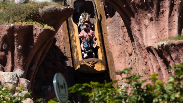 Guests ride the Splash Mountain attraction during the reopening of the Disneyland theme park in Anaheim, California, U.S., on Friday, April 30, 2021. Walt Disney Co.’s original Disneyland resort in California is sold out for weekends through May, an indication of pent-up demand for leisure activities as the pandemic eases in the nation’s most-populous state.