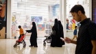 Women push strollers past a closed Adams Kids store at the Al Yasmin mall in Jeddah, Saudi Arabia, on Sunday, Aug. 6, 2017. After relying on oil to fuel its economy for more than half a century, Saudi Arabia is turning to its other abundant natural resource to take it beyond the oil age -- desert. Photographer: Tasneem Alsultan/Bloomberg