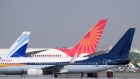 Aircraft operated by SpiceJet Ltd., from front, IndiGo, a unit of InterGlobe Aviation Ltd., and Air India Ltd. on the tarmac at the Indira Gandhi International Airport in New Delhi, India, on Tuesday, Sept. 28 2021. The India government is attempting to sell state-run Air India after two failed attempts. Despite the mounting debt and losses, the airline has some lucrative assets, including valued slots at London's Heathrow airport, a fleet of more than 100 planes and thousands of trained pilots and crew. Photographer: T. Narayan/Bloomberg