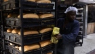 KAMPALA, UGANDA - JUNE 14: A baker makes bread, made from wheat flour, at a bakery on June 14, 2022 in Kampala, Uganda. This factory, one of the largest in the country, bakes around 300,000 loafs of bread a month and has had to raise prices in response to the wheat price increasing. The company also produces flour, which it currently sells at UGX168,000/50kg, up from UGX138,000 two weeks ago, and expects to raise prices again in a few weeks to UGX190,000. Around half of Uganda's wheat imports come from Russia and Ukraine, where production and export have been diminished by the ongoing war. (Photo by Luke Dray/Getty Images)