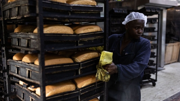 KAMPALA, UGANDA - JUNE 14: A baker makes bread, made from wheat flour, at a bakery on June 14, 2022 in Kampala, Uganda. This factory, one of the largest in the country, bakes around 300,000 loafs of bread a month and has had to raise prices in response to the wheat price increasing. The company also produces flour, which it currently sells at UGX168,000/50kg, up from UGX138,000 two weeks ago, and expects to raise prices again in a few weeks to UGX190,000. Around half of Uganda's wheat imports come from Russia and Ukraine, where production and export have been diminished by the ongoing war. (Photo by Luke Dray/Getty Images)