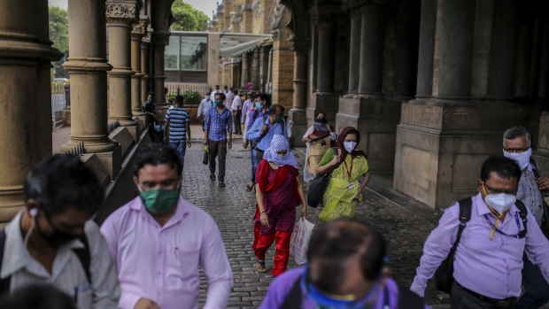 Commuters wearing protective masks exit the Chhatrapati Shivaji Maharaj Terminus (CST) railway station in Mumbai, India, on Monday, July 6, 2020. The Sensex is headed for a four-month high, even as India overtook Russia to become the country with the third-largest caseload of coronavirus infections. Only the U.S. and Brazil now have more infections than India.