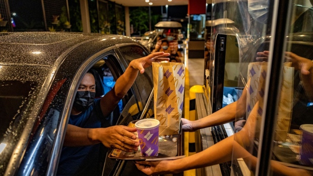 SAN FERNANDO, PHILIPPINES - JUNE 18: Customers order BTS meals at a McDonald's drive-thru during its launch on June 18, 2021 in San Fernando, Pampanga province, Philippines. Long queues formed in several McDonald's restaurants in the Philippines as fans of the K-pop group BTS flocked to order the newly launched and wildly popular BTS themed meals. The limited edition celebrity meal "BTS Meal", a collaboration between the fastfood giant and BTS, will be made available in 49 countries. (Photo by Ezra Acayan/Getty Images) Photographer: Ezra Acayan/Getty Images AsiaPac