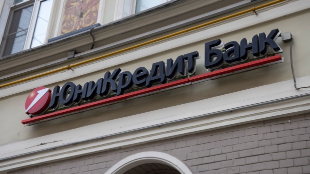 A sign above the entrance to a branch of Unicredit Bank AO in Moscow, Russia, on Wednesday, Feb. 23, 2022. U.S. President Joe Biden's debut set of sanctions on Russia for its actions over disputed Ukrainian territory hit markets with a whimper and were quickly criticized as limited in scope.