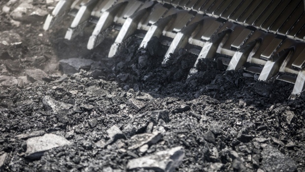 A front loader moves coal at the Tori Siding on the Tori-Shivpur rail line, operated by Indian Railways and funded by Coal India Ltd., in Chandwa, Jharkhand, India, on Thursday, May 17, 2018. State miner Coal India's output and shipments jumped to seasonal records in June, buoyed by summer demand from power stations, the company's biggest customers. Photographer: Prashanth Vishwanathan/Bloomberg
