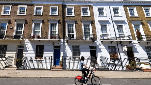 A cyclist on a Santander hire bicycle passes residential properties in Pimlico in London, UK, on Monday, June 20, 2022. The price of London's swankiest properties gained the most in more than seven-years last month as returning demand for city center homes tempt sellers to cash out.