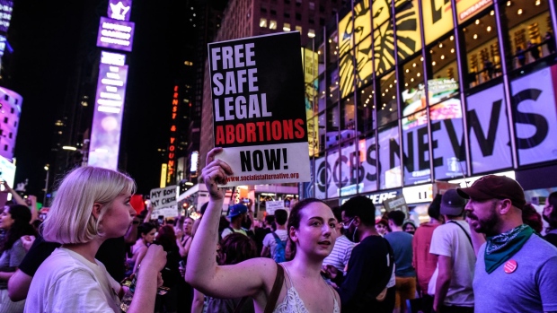 Abortion rights demonstrators hold signs while walking through Times Square during a protest in New York, US, on Friday, June 24, 2022. A deeply divided US Supreme Court overturned the 1973 Roe v. Wade decision and wiped out the constitutional right to abortion, issuing a historic ruling likely to render the procedure largely illegal in half the country. Photographer: Stephanie Keith/Bloomberg