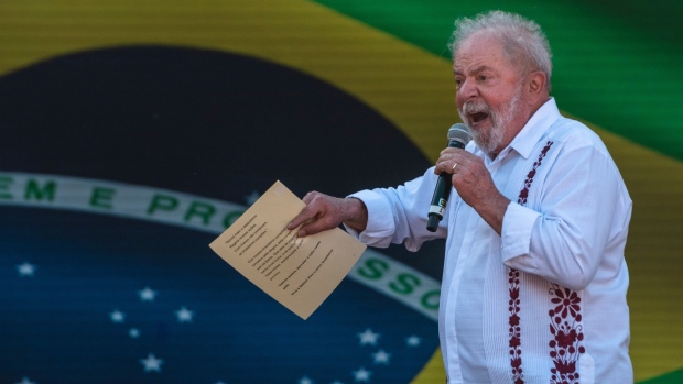 Luiz Inacio Lula da Silva, Brazil's former president, speaks as his wife Rosangela da Silva listens at a rally during Bahia's Independence Day in Salvador, Bahia state, Brazil, on Saturday, July 2, 2022. Former leftist president Lula still leads the Brazilian presidential race in a potential runoff against incumbent Jair Bolsonaro, a survey carried out between June 20-24 by Futura for Modalmais shows.