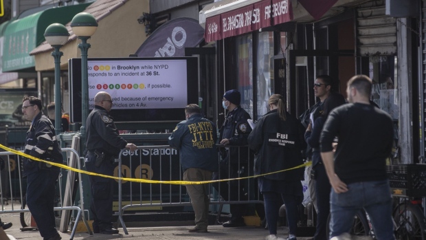 Law enforcement officers at the scene of a shooting at the 36th Street subway station in the Sunset Park neighborhood in the Brooklyn borough of New York, U.S., on Tuesday, April 12, 2022. A New York City shooter remains at large after 16 people were injured, including 10 people with gunshot wounds, during a chaotic Tuesday morning-rush-hour incident at a subway station in Sunset Park, Brooklyn.