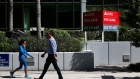 Pedestrians walk past Cushman & Wakefield Inc. signage in front of an office building for lease in the Brickell neighborhood of Miami, Florida, U.S., on Friday, Sept. 30, 2016. While overall U.S. home inventory continued to decline in July on a year-over-year basis, a fifth of the nation's 100 largest markets saw increases in supply, according to a report Wednesday from real estate search engine Trulia. Half of the top 10 gainers were communities in Florida. Photographer: Scott McIntyre/Bloomberg