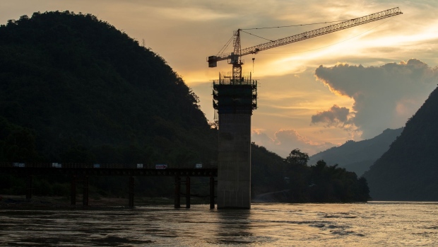 The Ban Ladhan Railway bridge, a section of the China-Laos Railway built by the China Railway Group Ltd., stands under construction on the Mekong River in Ban Ladhan, Luang Prabang province, Laos, on Thursday, Oct. 18, 2018. China's Belt and Road initiative plans to connect Southeast Asian countries with the southwest region of Yunnan through a series of high-speed railways. There are three routes planned: a central one that runs through Laos, Thailand and Malaysia to reach Singapore; a western route through Myanmar; and an eastern one through Vietnam and Cambodia. Photographer Taylor Weidman/Bloomberg Photographer: Taylor Weidman/Bloomberg