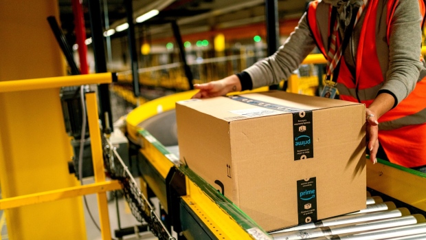 A worker collects a package at an Amazon.com Inc. fulfillment center in Frankenthal, Germany. 