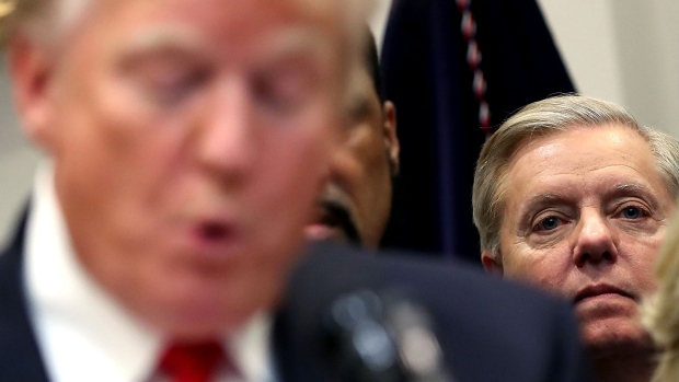 WASHINGTON, DC - NOVEMBER 14: Sen. Lindsey Graham (R-SC) (R) listens to U.S. President Donald Trump make an announcement regarding the "First Step Act", prison reform bill, in the Roosevelt Room at the White House on November 14, 2018 in Washington, DC. (Photo by Mark Wilson/Getty Images)
