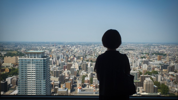 A visitor looks out a view of Sapporo, Japan, on Wednesday, Aug. 19, 2020. The Japan National Tourism Organization's monthly statistics on the number of foreign visitors to Japan and Japanese oversea travelers will be released on Aug. 21. Photographer: Kentaro Takahashi/Bloomberg