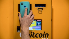 A customer scans a mobile phone QR code on cryptocurrency automated teller machine (ATM) inside a BitBase cryptocurrency exchange in Barcelona, Spain, on Monday, May 16, 2022. The wipeout of algorithmic stablecoin TerraUSD and its sister token Luna knocked more than $270 billion off the crypto sector’s total trillion-dollar value in the most volatile week for Bitcoin trading in at least two years.