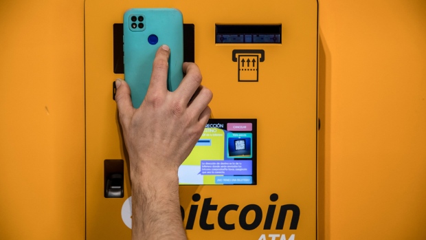 A customer scans a mobile phone QR code on cryptocurrency automated teller machine (ATM) inside a BitBase cryptocurrency exchange in Barcelona, Spain, on Monday, May 16, 2022. The wipeout of algorithmic stablecoin TerraUSD and its sister token Luna knocked more than $270 billion off the crypto sector’s total trillion-dollar value in the most volatile week for Bitcoin trading in at least two years.