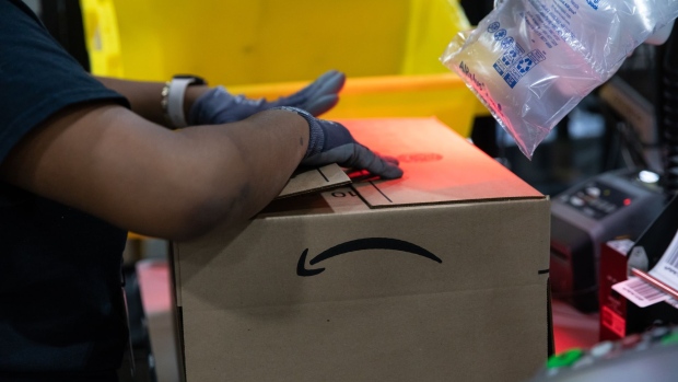 A worker assembles a box at an Amazon fulfillment center on Prime Day in Raleigh, North Carolina, U.S., on Monday, June 21, 2021. Amazon.com Inc.'s annual Prime Day sale, which begins Monday, arrives as the world grapples with the lingering effects of the pandemic.