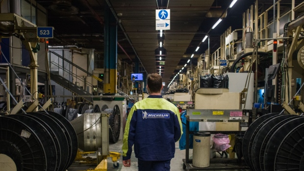 An employees walks past reels of rubber on the production line at the Michelin Gravanche manufacturing plant in Clermont Ferrand, France, on Wednesday, Feb. 16, 2022. Michelin said this year will be just as much of a struggle as 2021 as severe bottlenecks in supply chains and transportation routes drive up costs.