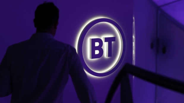 An attendee passes a BT Group Plc logo during a news conference in London, U.K., on Wednesday, Oct. 9, 2019. BT is making a new push to improve customer service, including the arrival of BT-branded shops for the first time in almost two decades, as Chief Executive Officer Philip Jansen begins a charm offensive to defend market share. Photographer: Hollie Adams/Bloomberg