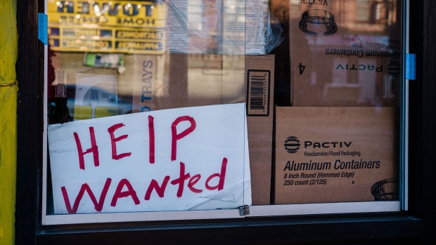 A "Help Wanted" sign outside a restaurant in the East Flatbush neighborhood in the Brooklyn borough of New York, U.S., on Monday, March 29, 2021.The U.S. economy is on a multi-speed track as minorities in some cities find themselves left behind by the overall boom in hiring, according to a Bloomberg analysis of about a dozen metro areas. Photographer: Bloomberg/Bloomberg