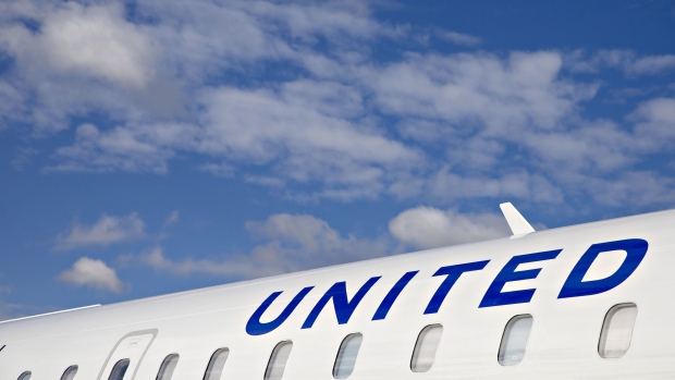 A United Airlines Holdings Inc. Bombardier CRJ-550 airplane sits at a gate at O'Hare International Airport (ORD) in Chicago, Illinois, U.S., on Thursday, Oct. 17, 2019. By putting premium perches on a small regional jet with a total of only 50 seats, United hopes to close an amenities gap for a highly competitive group of travelers from smaller cities to its Chicago and Newark, New Jersey hubs.
