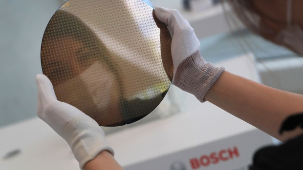 A worker holds a 200mm silicon wafer at the semiconductor fabrication (fab) plant, operated by Robert Bosch GmbH in Dresden, Germany, on Monday, May 31, 2021. Bosch agreed to cooperate with Globalfoundries — an Abu Dhabi-owned chip manufacturer with plants in the U.S., Singapore and Germany — to develop automotive radar semiconductors that should hit the market in the second half of this year.