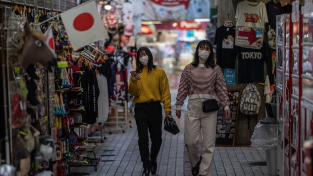 TOKYO, JAPAN - DECEMBER 01: Women wearing face masks walk through a shopping arcade on December 1, 2021 in Tokyo, Japan. Japan confirmed a second case of the Omicron variant of coronavirus today in a man arriving from Peru. The government also announced an entry ban on all foreigners, including residents, from ten African countries believed to have outbreaks of the COVID-19 strain. (Photo by Carl Court/Getty Images)