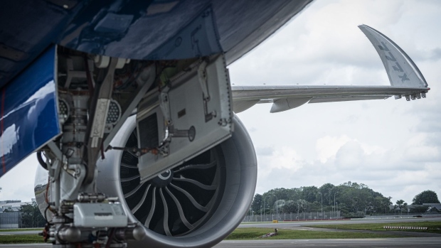 The engine and wing tip of the Boeing 777X test aircraft on the tarmac at Changi Airport, in Singapore, on Sunday, Feb. 13, 2022. The plane is in Singapore as part of the Singapore International Airshow.