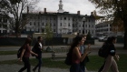 Students walk past Dartmouth Hall, under renovation, on the campus of Dartmouth College in Hanover, New Hampshire, U.S., on Friday, Oct. 15, 2021. Dartmouth College’s endowment returned 47% in the fiscal year that ended in June, the latest university to post some of the strongest investment gains in decades.