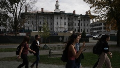 Students walk past Dartmouth Hall, under renovation, on the campus of Dartmouth College in Hanover, New Hampshire, U.S., on Friday, Oct. 15, 2021. Dartmouth College’s endowment returned 47% in the fiscal year that ended in June, the latest university to post some of the strongest investment gains in decades.