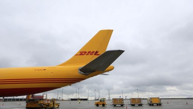 An Airbus A300-600 cargo aircraft stands on the tarmac as Deutsche Post AG's DHL package operation opens a new international express hub at Leipzig-Halle Airport in Leipzig, Germany, on Wednesday, Oct. 12, 2016. Deutsche Post last month agreed to buy independent British letter and parcel delivery service UK Mail Group Plc in an effort to boost its presence in a market dominated by formerly state-controlled Royal Mail Plc. Photographer: Krisztian Bocsi/Bloomberg