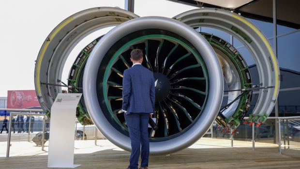 An attendee looks at a model of a Pratt & Whitney engine on the opening day of the Farnborough International Airshow in Farnborough, UK, on July 18.