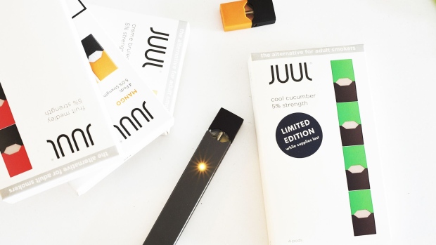 A Juul Labs Inc. e-cigarette, and USB charger