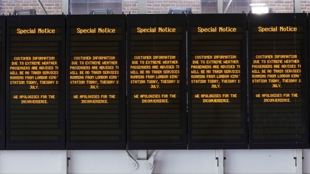 Screens displaying train cancellation information due to extreme weather during a heat wave at London King's Cross railway station in London, on July 19. Photographer: Chris Ratcliffe/Bloomberg