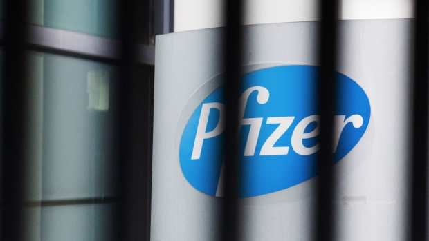 A logo at the Pfizer Inc. French headquarters in Paris, France, on Tuesday, Nov. 10, 2020. A vaccine developed by Pfizer Inc. and BioNTech SE protects most people from Covid-19, according to a study whose early findings sent stock prices surging and were hailed by the top U.S. infectious-disease specialist as “extraordinary.” Photographer: Nathan Laine/Bloomberg