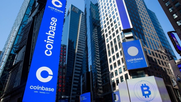 Monitors display Coinbase signage during the company's initial public offering (IPO) at the Nasdaq MarketSite in New York, U.S., on Wednesday, April 14, 2021. Coinbase Global Inc., the largest U.S. cryptocurrency exchange, is set to debut on Wednesday through a direct listing, an alternative to a traditional initial public offering that has only been deployed a handful of times. Photographer: Michael Nagle/Bloomberg