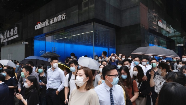 People stand in front of a Citigroup Inc. Citibank branch in the Central district during a protest in Hong Kong, China, on Wednesday, May 27, 2020. Officers fired pepper spray projectiles in downtown Hong Kong and arrested at least 16 people as protesters hit the streets Wednesday to oppose China's increasing control over the city, a return to unrest largely unseen since last year.