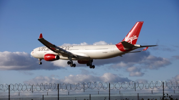 An Airbus SAS A330 passenger aircraft, operated by Virgin Atlantic Airways Ltd., prepares to land at Heathrow airport, in London, U.K., on Tuesday, Oct. 18, 2016. The U.K. government will decide next week whether to expand London's main airport, Heathrow, or its rival Gatwick putting an end to decades of prevarication over what has become one of the most contentious issues in British politics. Photographer: Chris Ratcliffe/Bloomberg