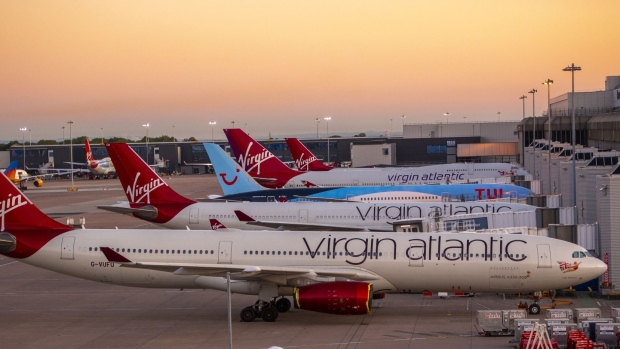 Passenger aircraft, operated by Tui AG and Virgin Atlantic Airways Ltd., sit grounded on the tarmac at Manchester Airport, operated by Manchester Airport Plc, in Manchester, U.K., on Monday, June 1, 2020. More than 200 U.K. travel and hospitality executives, including the head of London’s iconic Ritz hotel, joined a chorus of airlines and airports calling for the government to introduce air bridges to boost tourism and scrap contentious plans to quarantine visitors. Photographer: Anthony Devlin/Bloomberg