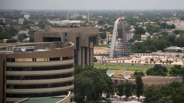The offices of the Caisse Nationale des Prevoyances Sociales, left, the Central Bank of Central African States, center, and the Arch of the Place de la Nation sit on the city skyline in N'Djamena, Chad, on Wednesday, Aug. 16, 2017. African Development Bank and nations signed agreement to finance a project linking the town of Ngouandere in Cameroon and Chad’s capital, N’Djamena, according to statement handed to reporters in Cameroonian capital, Yaounde in July. Photographer: Xaume Olleros/Bloomberg