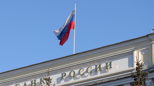 A Russian national flag at the headquarters of Bank Rossii, Russia's central bank, in Moscow, Russia, on Monday, Feb. 28, 2022. The Bank of Russia acted quickly to shield the nation’s $1.5 trillion economy from sweeping sanctions that hit key banks, pushed the ruble to a record low and left President Vladimir Putin unable to access much of his war chest of more than $640 billion. Photographer: Andrey Rudakov/Bloomberg