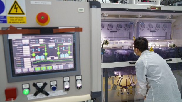 An employee inspects the roller electrospinning process during the manufacturing of nanofiber nonwoven fabric at a factory operated by Nanoshields Technology Ltd., a unit of King’s Flair International Ltd., in Hong Kong, China, on Tuesday, April 13, 2021. Nanoshields, a subsidiary of a Hong Kong maker of kitchenware that outsourced its manufacturing to the mainland in the 1990s, is working with local university researchers who developed a chemical that can be spun into a kind of fiber for use in water filters and face masks. Photographer: Lam Yik/Bloomberg