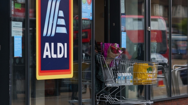A customer pushes a shopping trolley full of groceries at an Aldi Stores Ltd. supermarket in London, UK, on Friday, June 24, 2022. The Office for National Statistics said Friday the volume of goods sold in stores and online fell 0.5% in May, as soaring food prices forced consumers to cut back on spending in supermarkets.