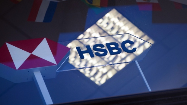 A company logo sits on display at the HSBC Holdings Plc headquarters on Champs Elysee in Paris, France, on Wednesday, July 29, 2020. HSBC is in the process of selling its French retail banking arm, which comprises 250 branches and several thousand employees. Photographer: Nathan Laine/Bloomberg
