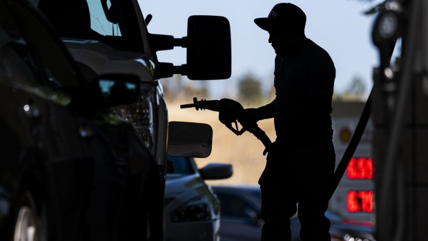 A customer holds a fuel nozzle at a Shell gas station in Hercules, California, U.S., on Wednesday, June 22, 2022. President Joe Biden called on Congress to suspend the federal gasoline tax, a largely symbolic move by an embattled president running out of options to ease pump prices weighing on his party's political prospects.