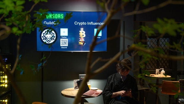 A monitor displays the logo of GuildQB and Crypto Influencer at CryptoBar P2P in the Ginza district of Tokyo, Japan, on Thursday, June 2, 2022. The membership bar for "crypto-tech and crypto-culture enthusiasts" accepts payment in cryptocurrencies only, according to the owner.